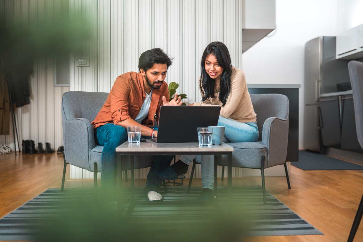 DFS Group Increases Online Store Conversion stock image of two people working on a laptop