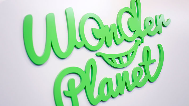 Wonder Planet company logo in green script lettering on a white background.